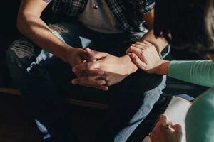 a person comforts another in an addiction aftercare program missouri