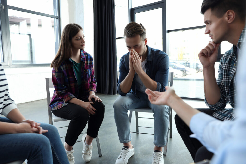 a group consoles a person during an addiction day treatment program missouri