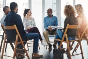 Seated people in a cognitive behavioral therapy program