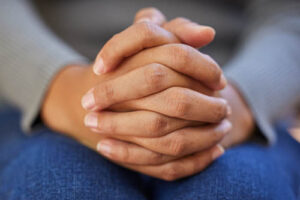 Clasped hands of a professional explaining co-occurring disorders treatment in Missouri to someone
