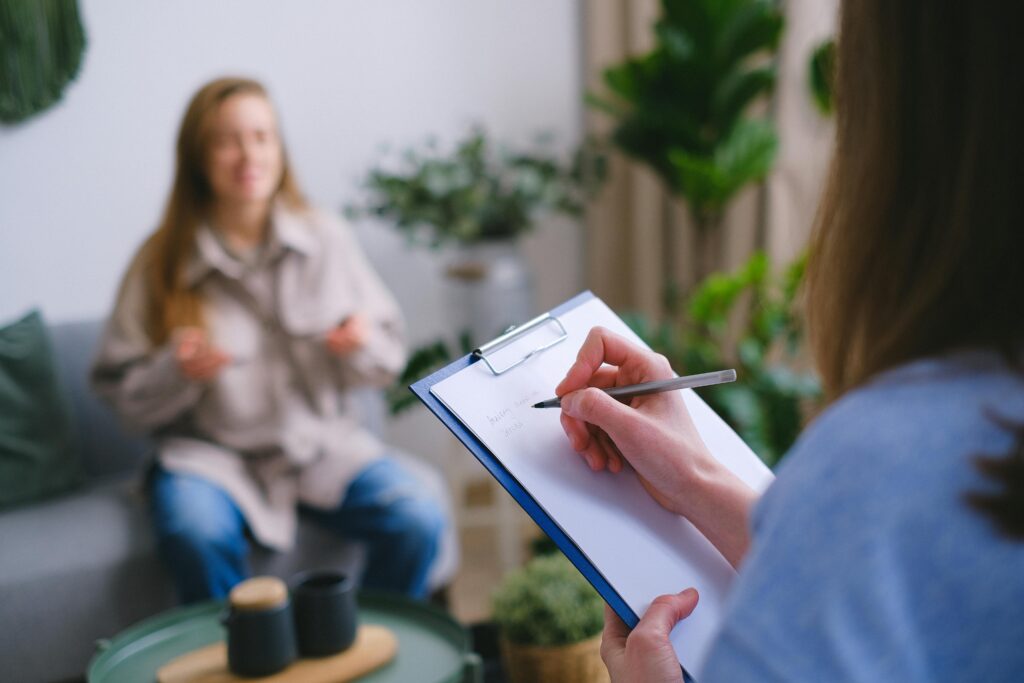 women sitting down experiencing a therapy session for their addiction recovery process